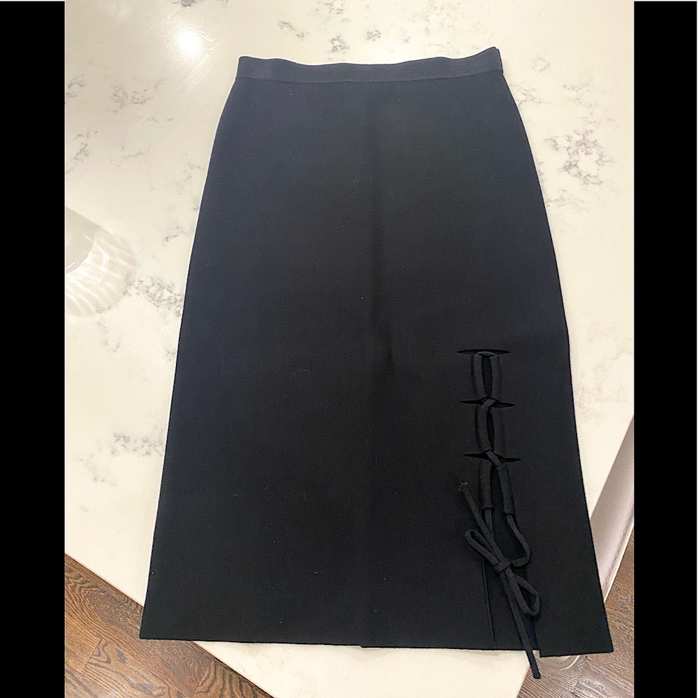 Mid length black skirt with detailing on front left side. In perfect condition.